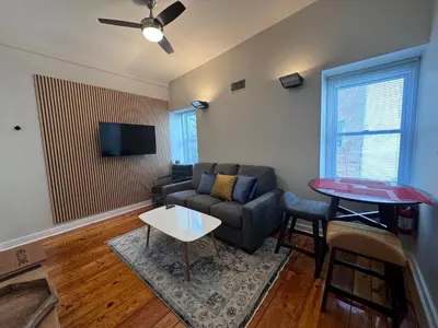 a living room with a couch and a table at 3961 Baltimore Penn Campus in Philadelphia