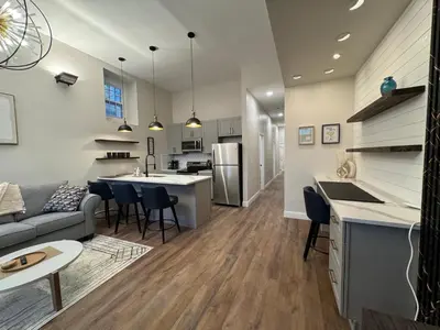 a kitchen and living room with a couch and a table at 3961 Baltimore Penn Campus in Philadelphia