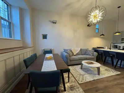 a living room with a table and a couch at 3961 Baltimore Penn Campus in Philadelphia
