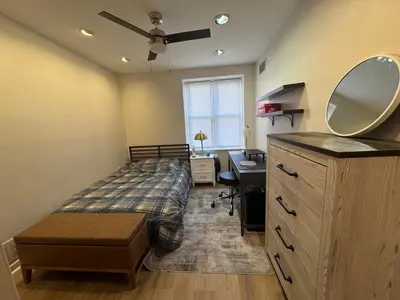 a bedroom with a bed and a desk and a mirror at 3961 Baltimore Penn Campus in Philadelphia