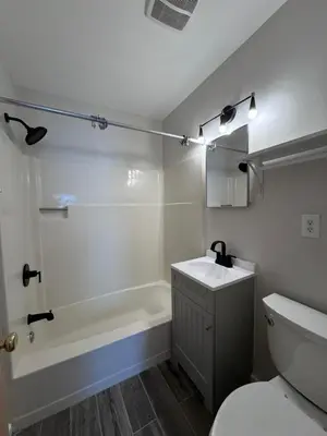 a bathroom with a toilet and a tub and a sink at 3961 Baltimore Penn Campus in Philadelphia