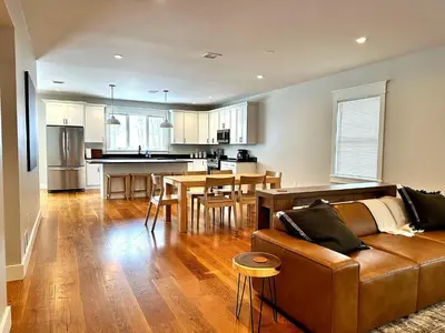a living room and kitchen with a couch and a table at Luxury 3BR with King Beds in Montgomery Village in Montgomery