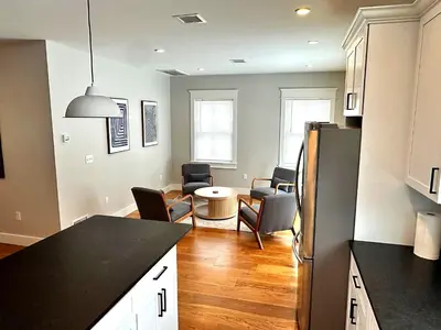 a kitchen and living room with a table and chairs at Luxury 3BR with King Beds in Montgomery Village in Montgomery