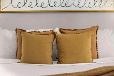 a bed with pillows and a picture on the wall at Chic NYC Retreat Beside Broadway in New York