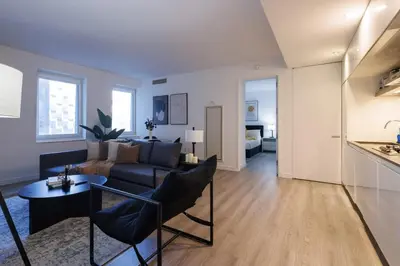 a living room with a couch and a table at Elegant NYC Haven Walk to Broadway in New York