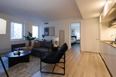 a living room with a couch and a table at Elegant NYC Haven Walk to Broadway in New York