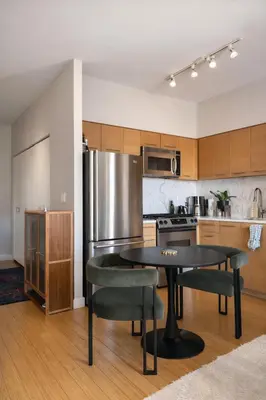 a kitchen with a table and chairs and a refrigerator at Stylish Midtown Escape Near Bryant Park in New York