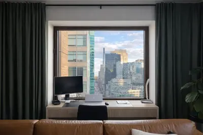 a room with a window with a desk and a computer at Stylish Midtown Escape Near Bryant Park in New York