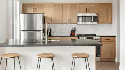 a kitchen with a counter and two stools in it at Landing Spectacular 1BD Clubhouse Gym in Philadelphia