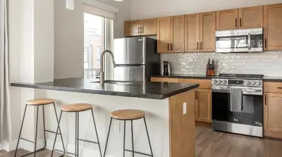 a kitchen with a black counter top and stools at Landing Spectacular 1BD Clubhouse Gym in Philadelphia