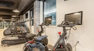 a gym with two exercise bikes and a flat screen tv at Landing Spectacular 1BD Clubhouse Gym in Philadelphia