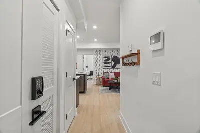 a hallway with a door leading to a living room at Stylish 1BR Apartment Near Center City & University City in Philadelphia