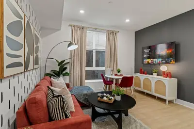 a living room with a red couch and a table at Stylish 1BR Apartment Near Center City & University City in Philadelphia