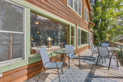 a patio with chairs and a table on a house at Huge Waterfront Home with Dock on Lake Wallenpaupack in Hawley