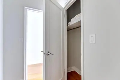 a room with a closet with a white door at Blueground Murray Hill fitness center nr Bryant Park NYC-2171 in New York