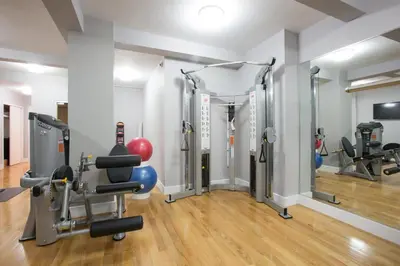 a gym with treadmills and machines in a room at Blueground Murray Hill fitness center nr Bryant Park NYC-2171 in New York