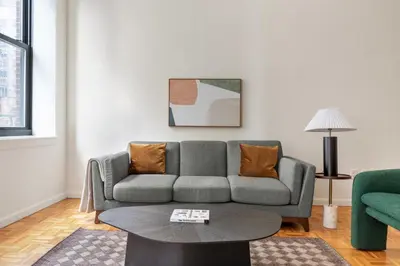 a living room with a couch and a table at Blueground Financial District rooftop nr Brooklyn Bridge NYC-2201 in New York