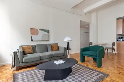 a living room with a couch and a table at Blueground Financial District rooftop nr Brooklyn Bridge NYC-2201 in New York