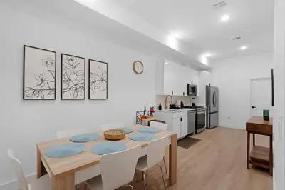 a kitchen and dining room with a table and chairs at Spacious Duplex only 15 Minutes to NYC with Firepit Perfect for Groups in Jersey City