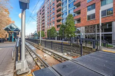 an empty train track in a city with buildings at Spacious Duplex only 15 Minutes to NYC with Firepit Perfect for Groups in Jersey City
