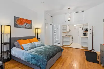 a living room with a bed and a kitchen at Stylish Studio in Central Park in Best Location Ever in New York