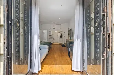 a hallway with curtains and a room with a bed at Stylish Studio in Central Park in Best Location Ever in New York