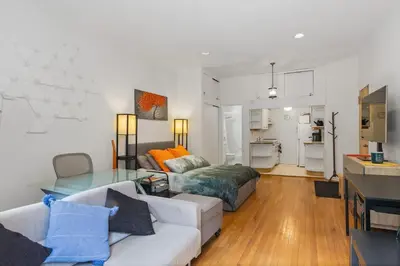 a living room with a couch and a table at Stylish Studio in Central Park in Best Location Ever in New York