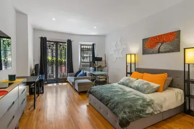 a bedroom with a bed and a living room at Stylish Studio in Central Park in Best Location Ever in New York
