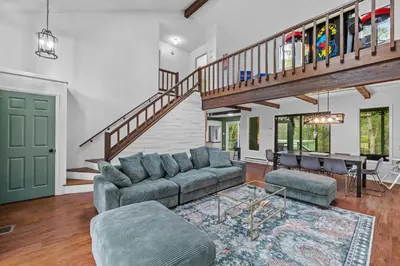 a living room with a couch and a table at Pocono Serenity Retreat | 3-BR w/ Bonus King Suite & Hot Tub by Stay Lage in East Stroudsburg