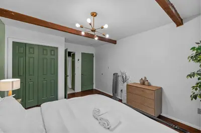 a bedroom with green doors and a bed at Pocono Serenity Retreat | 3-BR w/ Bonus King Suite & Hot Tub by Stay Lage in East Stroudsburg