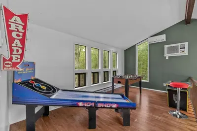 a room with a ping pong table and a game table at Pocono Serenity Retreat | 3-BR w/ Bonus King Suite & Hot Tub by Stay Lage in East Stroudsburg