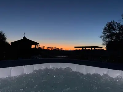 a view of the sunset over a swimming pool at County Peace with Luxurious Amenities