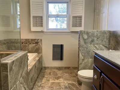 a bathroom with a tub and a toilet and a sink at County Peace with Luxurious Amenities