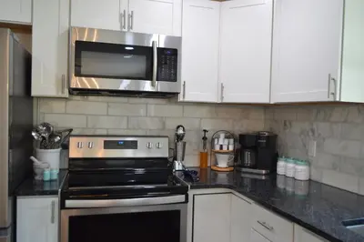 a kitchen with a stove and a microwave at County Peace with Luxurious Amenities