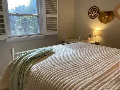 a bed in a bedroom with a window at County Peace with Luxurious Amenities