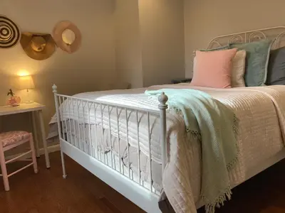 a bedroom with a bed with a crib and a table at County Peace with Luxurious Amenities