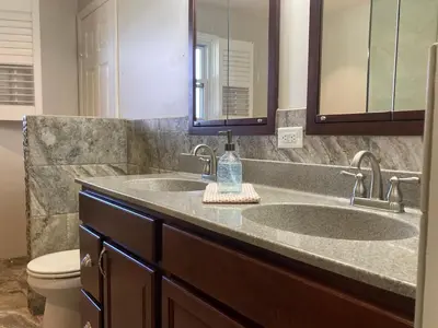 a bathroom with two sinks and a toilet at County Peace with Luxurious Amenities