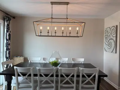 a dining room with a black table and white chairs at County Peace with Luxurious Amenities