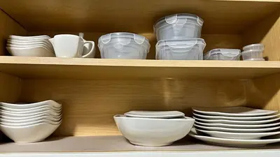 a wooden shelf with plates and cups and dishes at Cozy Stay with Games, 15 min to NYC, Private Backyard - Sleeps 6 - NEAR METLIFE STADIUM in Jersey City