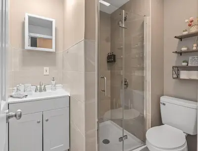 a bathroom with a shower and a toilet and a sink at Cozy Stay with Games, 15 min to NYC, Private Backyard - Sleeps 6 - NEAR METLIFE STADIUM in Jersey City