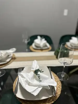 a table with a plate with a napkin and a glass at Cozy Stay with Games, 15 min to NYC, Private Backyard - Sleeps 6 - NEAR METLIFE STADIUM in Jersey City
