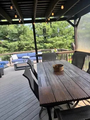 a wooden table and chairs on a wooden deck at Private oasis near Lititz in Lancaster