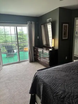 a bedroom with a bed and a television and a balcony at Private oasis near Lititz in Lancaster