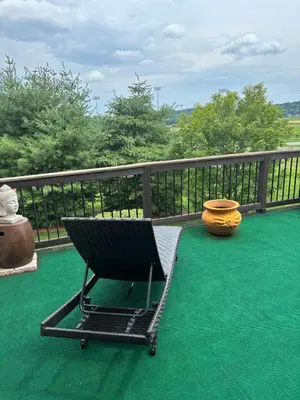 a black chair on a balcony with a vase at Private oasis near Lititz in Lancaster