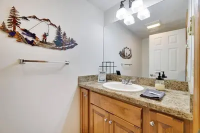 a bathroom with a sink and a mirror at Spacious Lake Front Winter Retreat! Less than 10 Min to Big Boulder! in Blakeslee