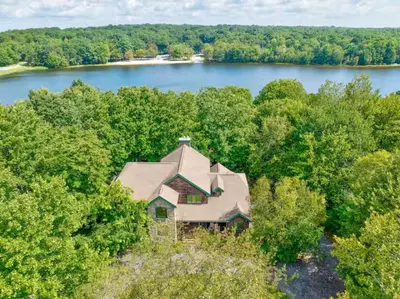 an aerial view of a house in the middle of a lake at Spacious Lake Front Winter Retreat! Less than 10 Min to Big Boulder! in Blakeslee
