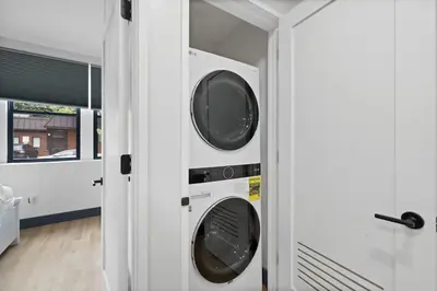 a laundry room with two washing machines in it at Luxury Brand New 3BED Gem 20 Minutes to NYC in Jersey City