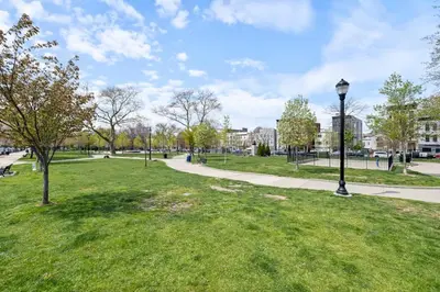 a park with green grass and a street light at Luxury Brand New 3BED Gem 20 Minutes to NYC in Jersey City