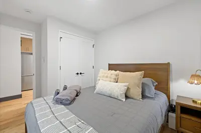 a bedroom with a large bed with pillows on it at Luxury and Trendy 3BR 2BA APT only 20 minutes to New York in Jersey City