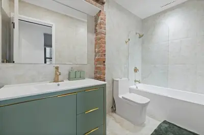 a bathroom with a sink and a toilet and a shower at Luxury and Trendy 3BR 2BA APT only 20 minutes to New York in Jersey City